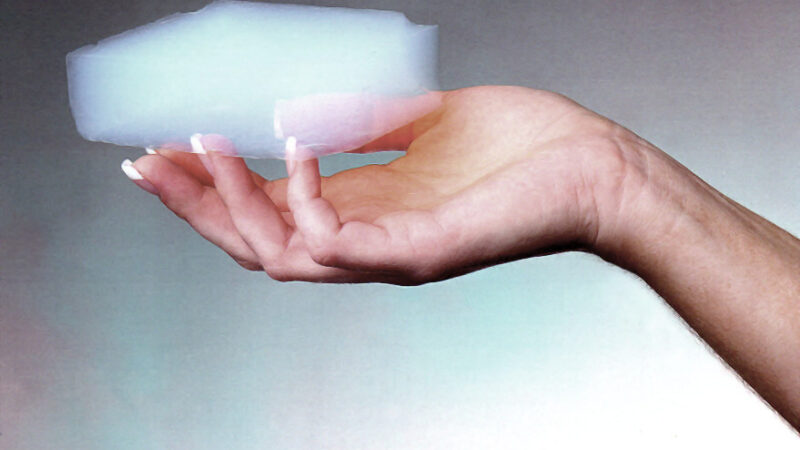 Blue silica aerogel monolith held in a hand to illustrate aerogel product forms